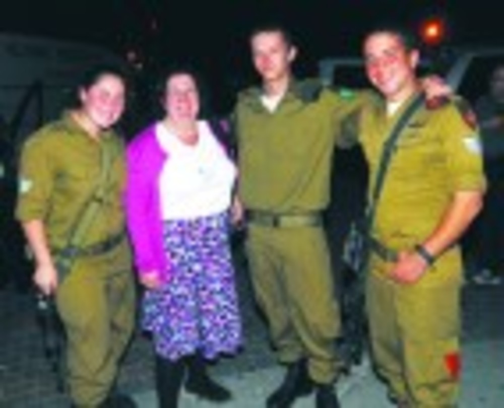 Janice Adler, who participated in the Jewish Alliance of Greater Rhode Island’s mission to Israel in January 2013, stands with  Lone Soldiers Tal, left, Max and David in Israel. /Michael Meyerheim